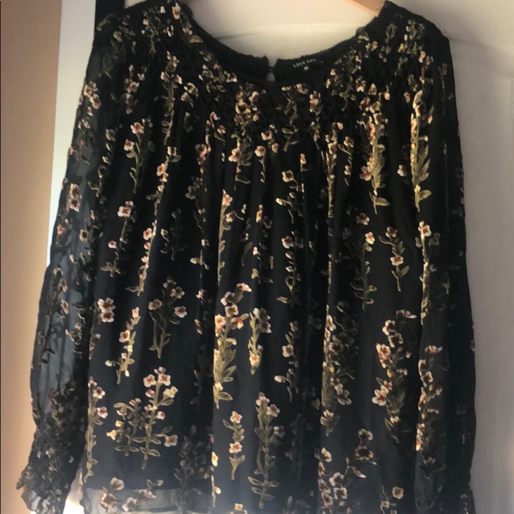Chiffon top with velvet flower detail.